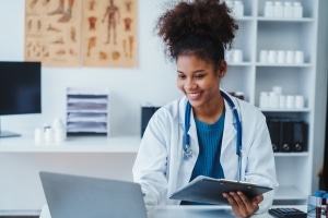 Smiling African-American medical professional at a desk