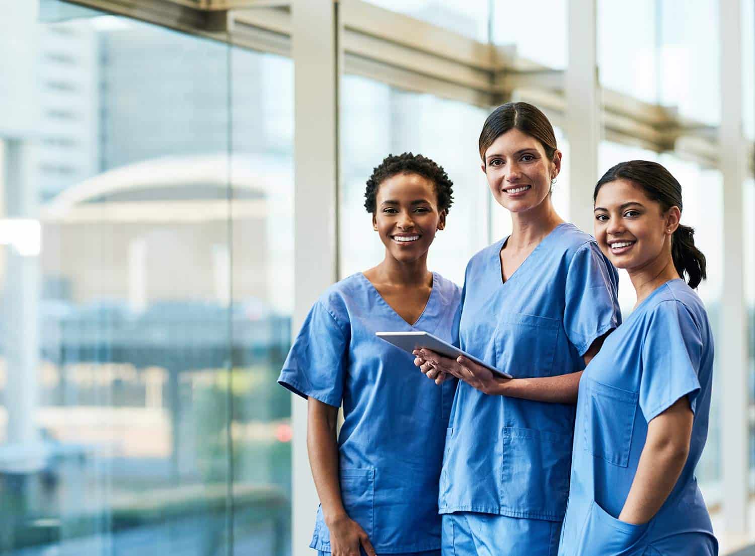 Diverse group of female nurses standing in a hallway